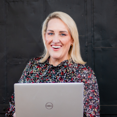 PM Jen sitting in front of her laptop